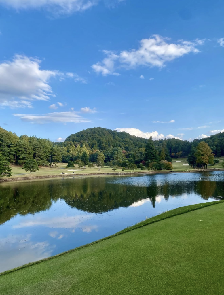Kyoto Golf Club Kamigamo Course - tranquil pond reflecting forested hills and manicured fairway